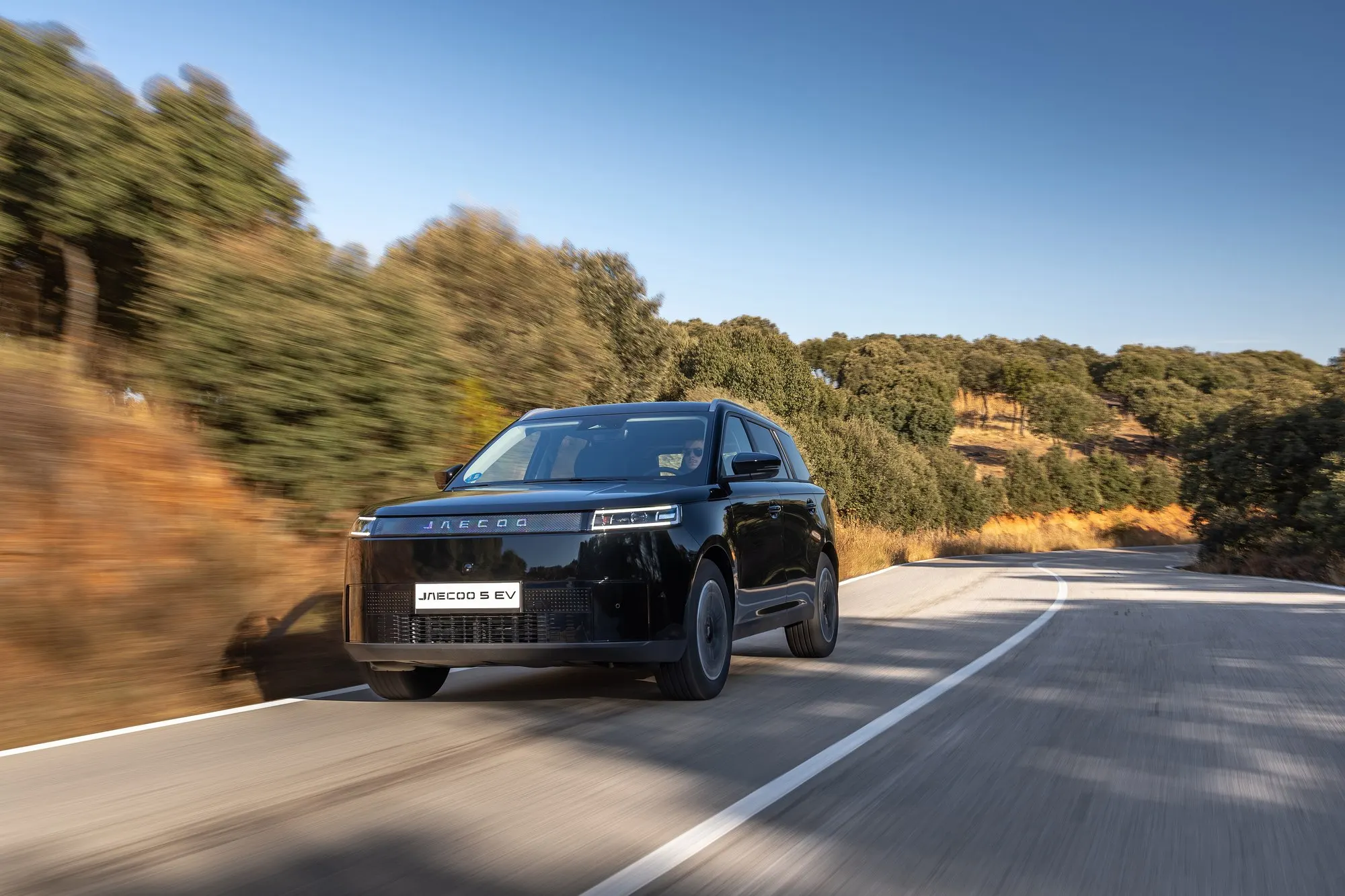 Jaecoo 5 EV in Schwarz während der Fahrt, schräge Frontansicht