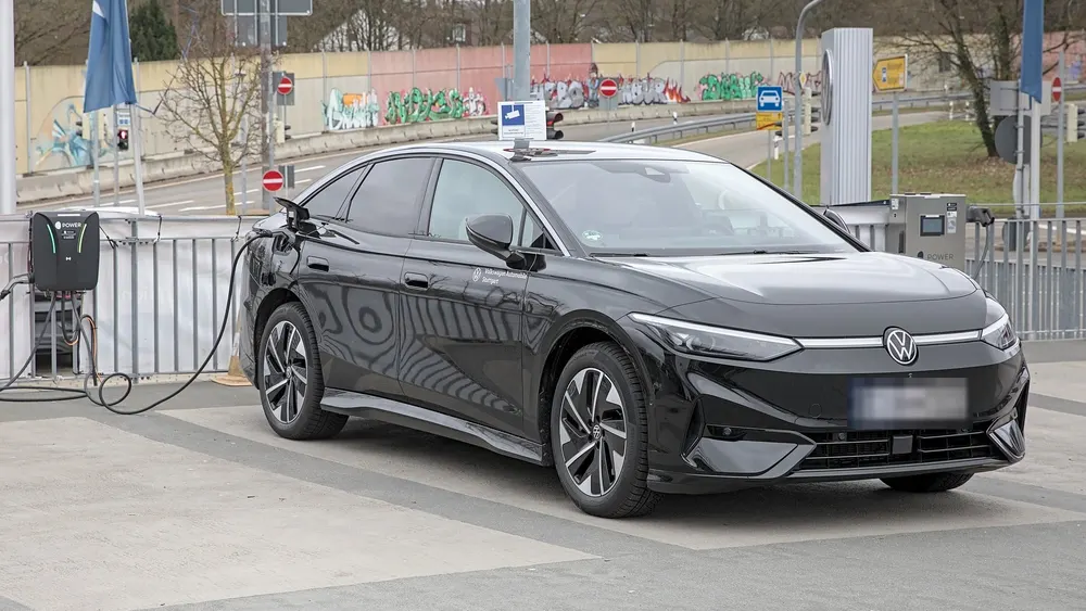 Schwarzer VW ID.7 lädt mit Ladekabel an einer Wallbox
